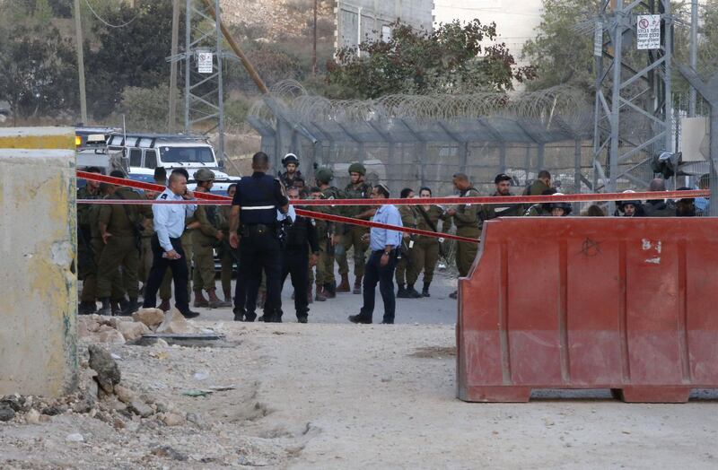 Israeli soldiers gather in the settlement of Kiryat Arba in the West Bank town of Hebron after a Palestinian was shot dead at a similar checkpoint earlier. AFP