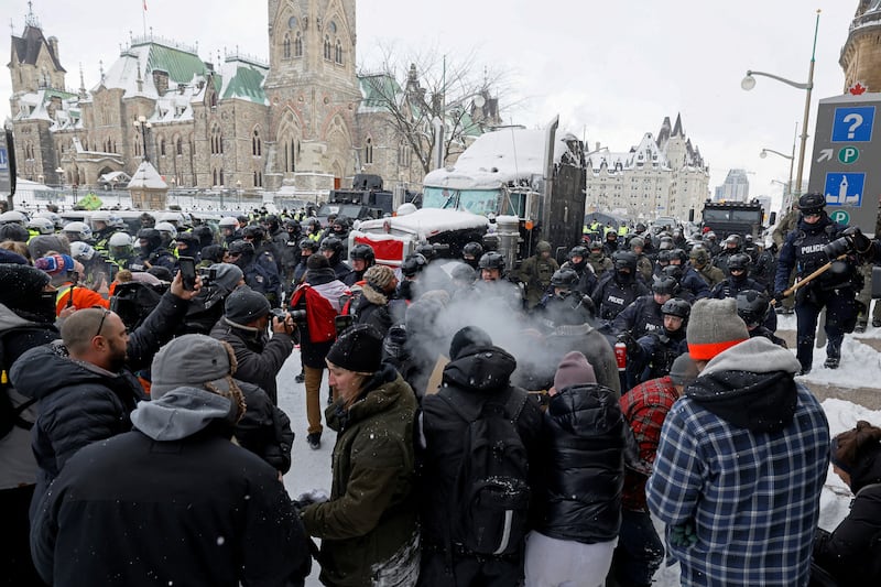 Canadian police officers march on protesters at Parliament Hill in Ottawa. Photo: Reuters