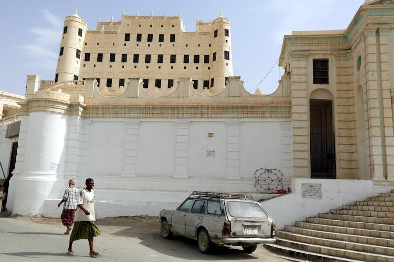 Yemenis walk past the palace of Sultan Al Kathiri in the southeast city of Seiyun, Yemen. Part of the palace is now used as an archaeological museum.  EPA