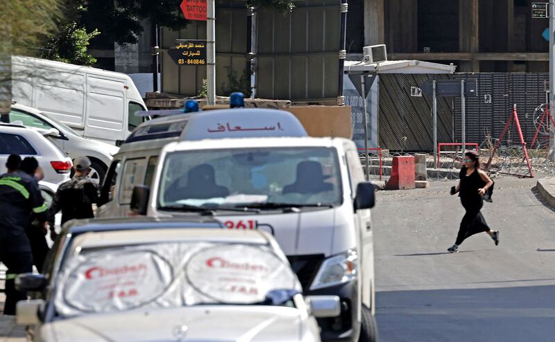 A woman crosses the road towards Lebanese medics during the clashes. AFP