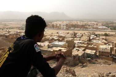 A Yemeni sits on a mountain overlooking the mud-brick 'skyscrapers' of the ancient walled city of Shibam in Hadramout province, Yemen, 12 July, 2018. EPA