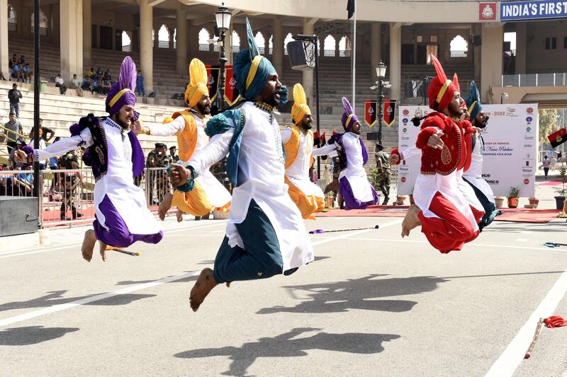 Students perform Bhangra during the closing ceremony of the 'Seema Prahari Marathon' at the India-Pakistan Wagah border post. AFP