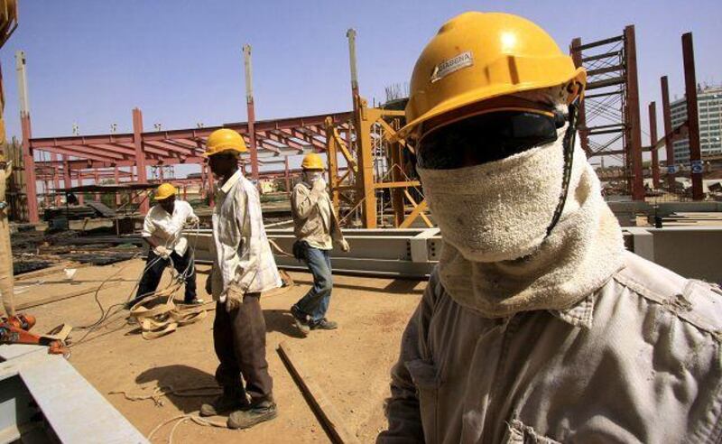 Symbiotic relationship: a Chinese engineer oversees work on a construction site in Khartoum.