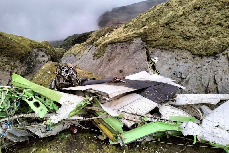 This handout photograph taken on May 30, 2022 and released by the Nepal Police shows the wreckage of a Twin Otter aircraft, operated by Nepali carrier Tara Air, laying on a mountainside in Mustang, a day after it crashed.  - Nepali rescuers on May 30 retrieved 16 bodies from the mangled wreckage of a passenger plane strewn across a mountainside that crashed in the Himalayas with 22 people on board.  (Photo by Man Bahadur Basyal  /  Nepal Police  /  AFP)  /  -----EDITORS NOTE --- RESTRICTED TO EDITORIAL USE - MANDATORY CREDIT "AFP PHOTO / Nepal Police" - NO MARKETING - NO ADVERTISING CAMPAIGNS - DISTRIBUTED AS A SERVICE TO CLIENTS - NO ARCHIVES