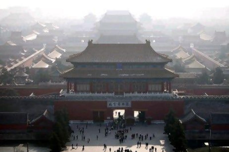 FILE - This Nov. 27, 2009 file photo shows haze clouding the skyline over the forbidden city in Beijing, China. For China, this decade was a time when the massive nation began to reshape the world in both basic and big ways. After spending much of the '80s and '90s with their heads down, retooling their shattered economy, the Chinese started peering beyond the horizon and striding out far beyond their borders. (AP Photo/Elizabeth Dalziel, File) *** Local Caption *** NY612_Decades_End_Chinas_Rise.jpg