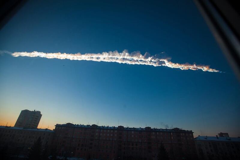 A 2013 file photo shows a meteorite contrail over the Ural Mountains' city of Chelyabinsk, about 930 miles east of Moscow. After it hit at 42,000mph and exploded, smashing windows and causing minor injuries, scientists said the threat of space rocks hurtling towards our planet is bigger than they had thought. AP / Chelyabinsk.ru