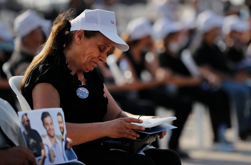 A relative of a victim of the blast weeps as she attends the Mass.