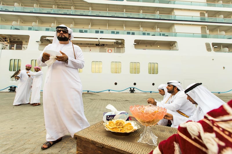 Abu Dhabi, United Arab Emirates, October 23, 2017:    Emirati men wait to greet passengers disembarking from the Seabourn Encore ship at the cruise terminal in the Mina Zayed area of Abu Dhabi on October 23, 2017. Christopher Pike / The National

Reporter: John Dennehy
Section: News