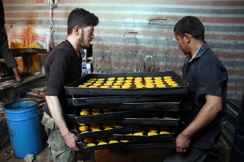 Afghan men prepare sweets at a traditional bakery for Eid Al Fitr holiday to mark the end of Ramadan. AP