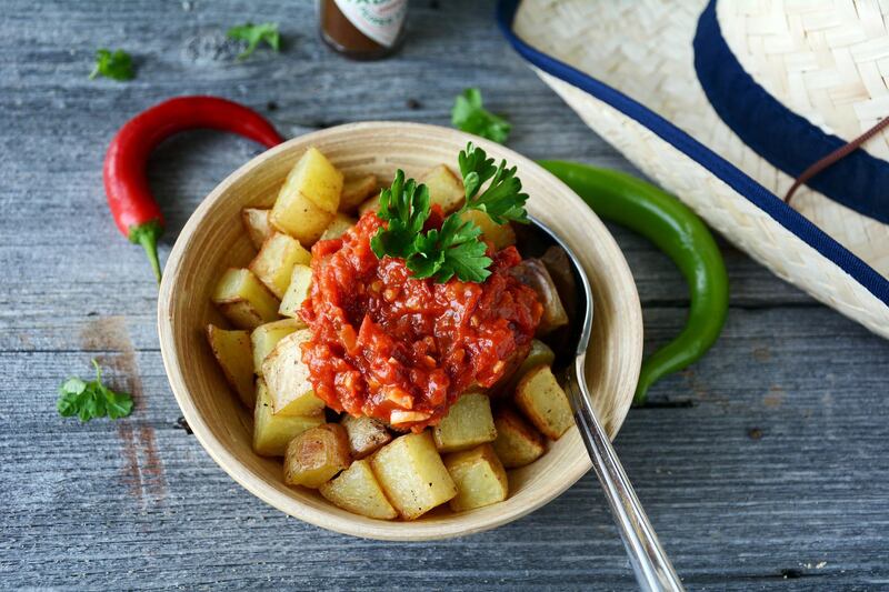 Hot spanish meal or tapas: baked potatoes with spicy tomato sauce