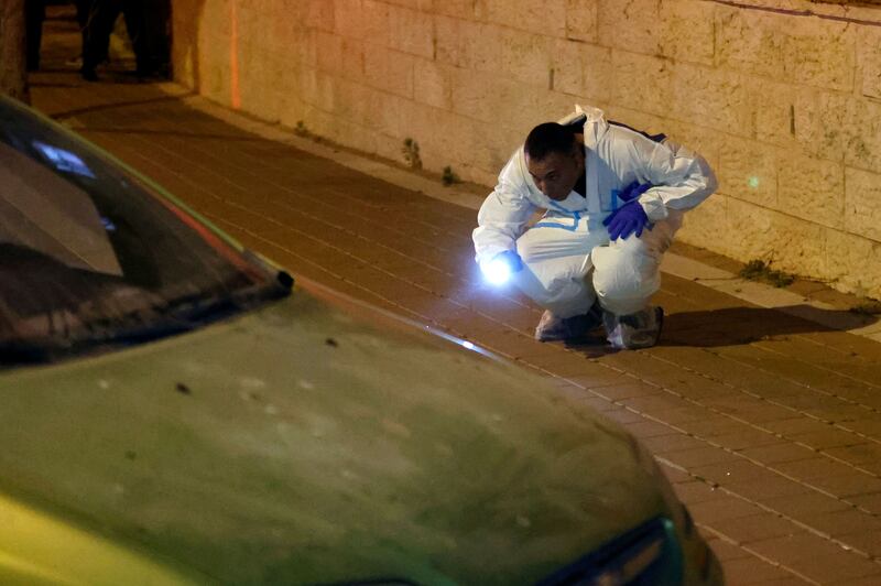 A police officer collects evidence at the scene of the crime. AFP