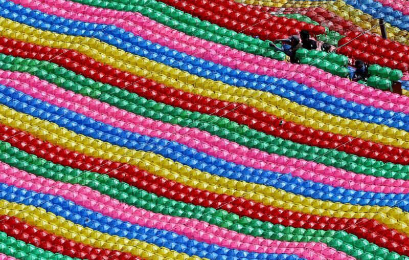 Workers hang lanterns for upcoming celebration of Buddha's birthday on May 22 at Jogye temple in Seoul, South Korea. Ahn Young-joon / AP Photo