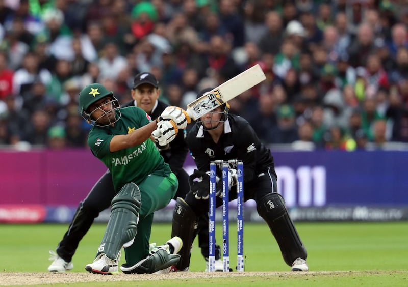 Pakistan's batsman Babar Azam, front, watches his shot as New Zealand's wicketkeeper Tom Latham, right, with teammate Ross Taylor looks on during the Cricket World Cup match between New Zealand and Pakistan at the Edgbaston Stadium in Birmingham, England, Wednesday, June 26, 2019. (AP Photo/Rui Vieira)