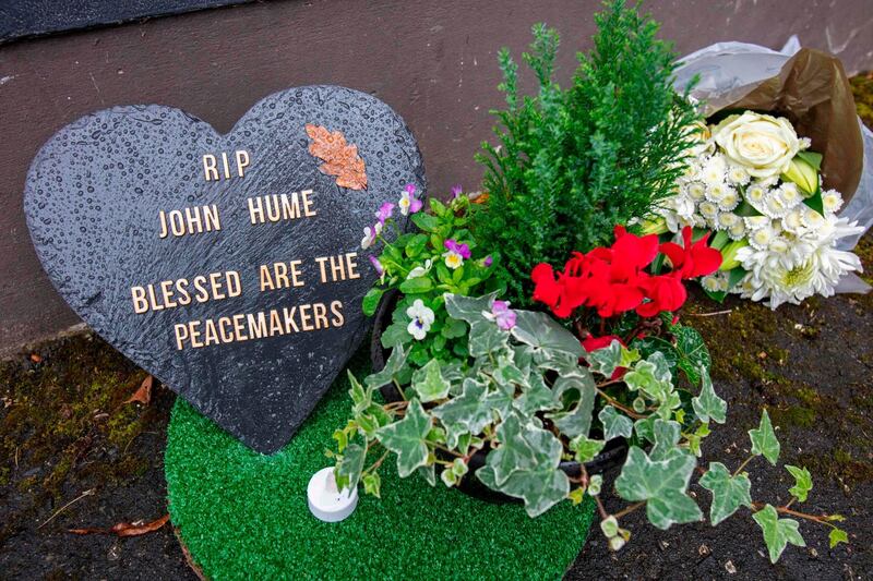 A floral tribute is pictured at the Free Derry wall in the Bogside area for John Hume in Derry. AFP