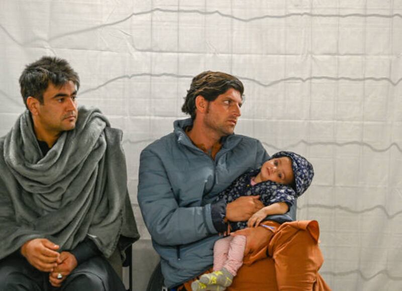 Recently-arrived refugees from Afghanistan wait for medical support at a temporary camp at the US Army's Rhine Ordnance Barracks, where they are being temporarily housed. Getty Images
