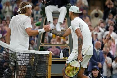 Australia's Nick Kyrgios shakes hands at the net with Greece's Stefanos Tsitsipas after winning their third round men's singles match on day six of the Wimbledon tennis championships in London, Saturday, July 2, 2022.  (AP Photo / Kirsty Wigglesworth)
