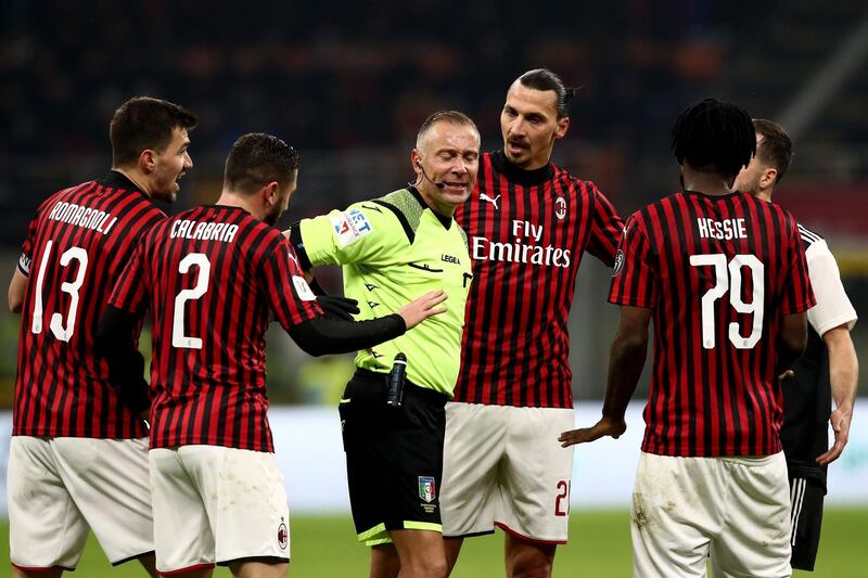 Zlatan Ibrahimovic and his AC Milan teammates argue with Paolo Valeri after the referee awarded Juve's late penalty. AFP