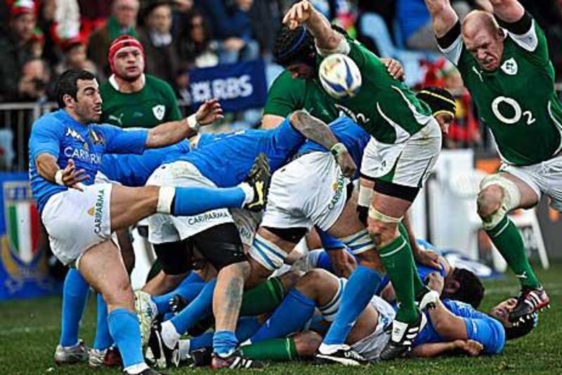 Italy's scrum-half Pablo Canavosio, left, kicks the ball out of the scrum at the Flaminio stadium in Rome.