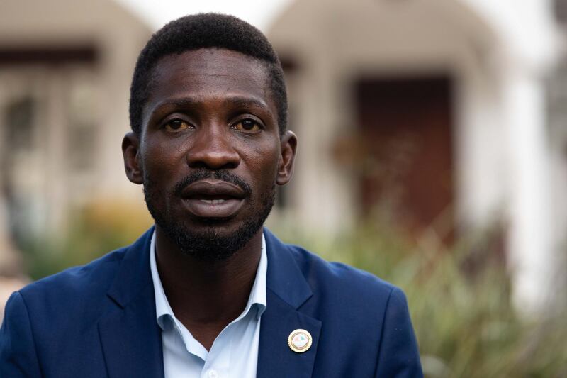 KAMPALA, UGANDA - JANUARY : Bobi Wine addresses the media as security forces surround his home on January , 2021 in Kampala, Uganda. Wine alleged that the forces beat a member of his staff shortly before the media arrived. A uniformed solider also pointed a cocked rifle at members of the media. Pop singer turned politician Bobi Wine is challenging sitting President Yoweri Museveni who is seeking his sixth term in office after 35 years in power. (Photo by Luke Dray/Getty Images)