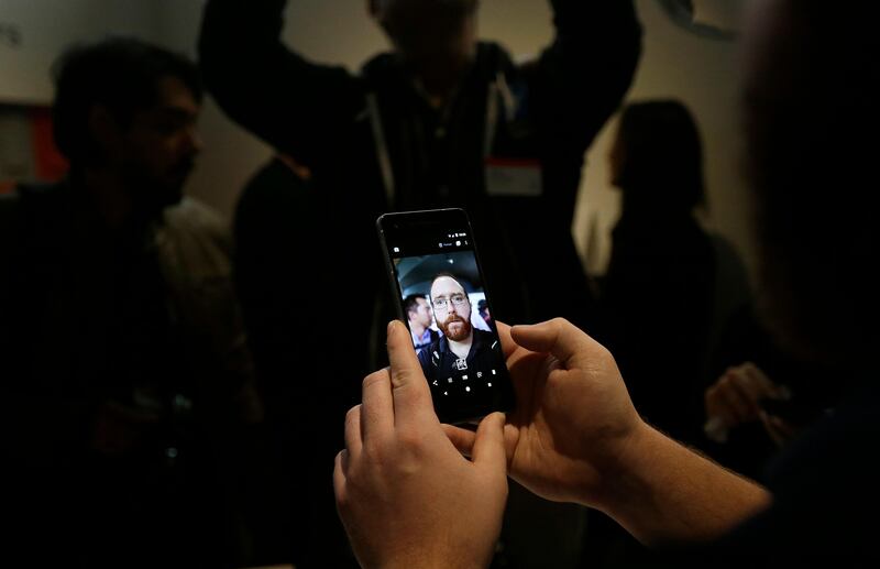 A man looks at a one of the new Google Pixel phones at a Google event at the SFJAZZ Center in San Francisco. Jeff Chiu / AP Photo