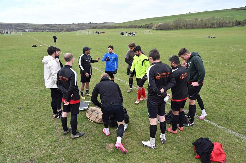 Players from Hangleton First hold a team meeting before their match in the Brighton, Worthing & District Football League in Brighton, after restrictions on outdoor sports were lifted. AFP