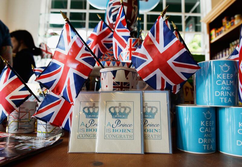 SANTA MONICA, CA - JULY 22: A baby announcement card and flags adorn the gift shop of Ye Olde King's Head English pub to celebrate the announcement of the birth of Catherine, Duchess of Cambridge, and her husband Prince William's first child, July 22, 2013 in Santa Monica, California. Kensington Palace announced that The Duchess of Cambridge gave birth to a baby boy with Prince William, Duke of Cambridge present for the birth.   Kevork Djansezian/Getty Images/AFP== FOR NEWSPAPERS, INTERNET, TELCOS & TELEVISION USE ONLY ==
 *** Local Caption ***  597531-01-09.jpg