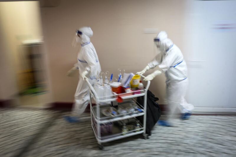 Medical workers bring medications to patients suffering from the coronavirus inside the Institute for Orthopaedic Surgery 'Banjica', recently transformed to a Covid-19 hospital, in Belgrade.   AFP