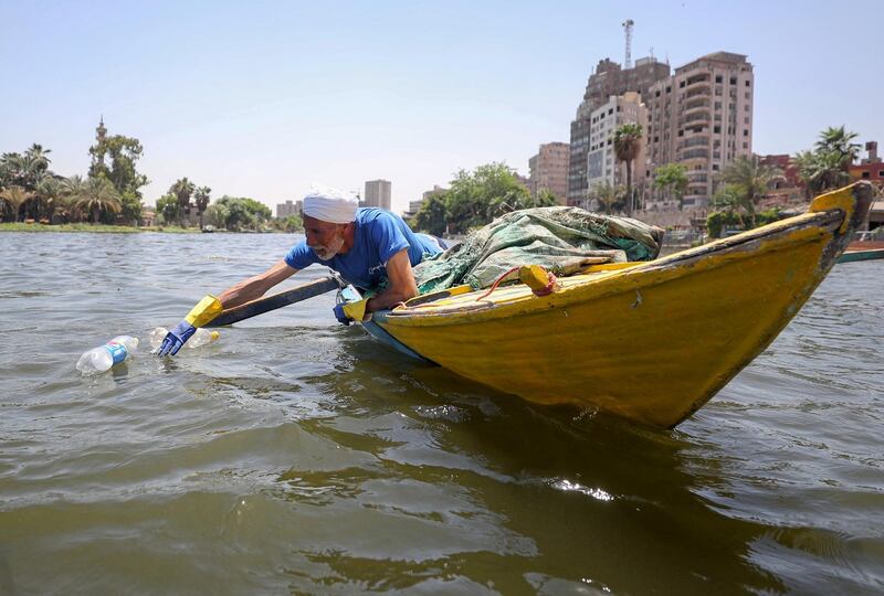 Fisherman Mohamed Nasar, 58, collects plastic waste from the Nile river in Giza, Egypt. Reuters
