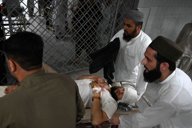 A man injured in the blast is taken into a hospital in Peshawar.  AFP