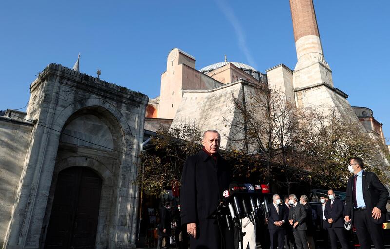 Turkey's President Recep Tayyip Erdogan speaks to the media after Friday prayers at Hagia Sophia Mosque, in Istanbul, Friday, Dec. 4, 2020. Erdogan has renewed his vitriolic attacks on French President Emmanuel Macron, saying he hopes France will get rid of him soon. Erdogan called Macron "trouble" for France, which he said was experiencing a dangerous time under his leadership. (Turkish Presidency via AP, Pool)