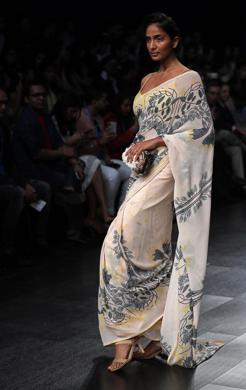 Bahl also presented a range of saris with multicoloured patchwork against creamy white fabrics. EPA