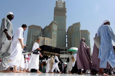 The tallest clock tower in the world with the world's largest clock face, atop the Abraj Al-Bait Towers, overshadows Muslim pilgrims as they circumambulate around the Kaaba, the cubic building at the Grand Mosque, in the Muslim holy city of Mecca, Saudi Arabia, Monday, Aug. 5, 2019. (AP Photo/Amr Nabil)