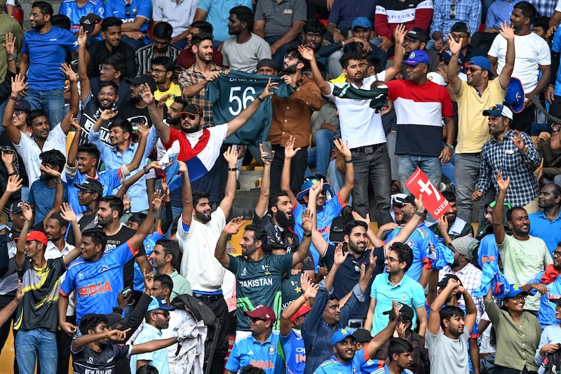 Spectators watch the 2023 ICC Men's Cricket World Cup one-day international match between New Zealand and Pakistan at the M. Chinnaswamy Stadium in Bengaluru. AFP

