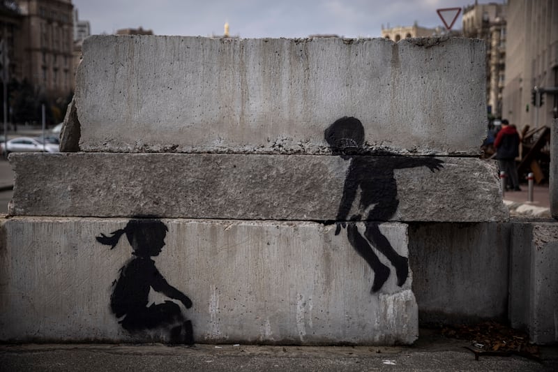 Street art of two children on blocks of concrete in Independence Square, Kyiv. Getty 