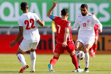 Iran's midfielder Alireza Jahanbakhsh (C) vies for the ball with Lebanon's midfielder Jihad Ayoub (R) during the 2022 Qatar World Cup Asian Qualifiers football match between Iran and Lebanon, at the Imam Reza Stadium in the city of Mashhad, on March 29, 2022.  (Photo by AFP)