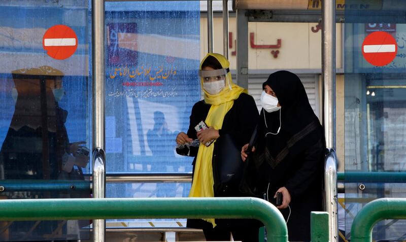 Iranian women wearing face masks wait in a bus station in a street of Tehran, Iran. According to the Iranian Health ministry, Iran reported its highest daily Covid-19 death toll by announcing 279 dead and 4,830 new infections in the past 24 hours.  EPA