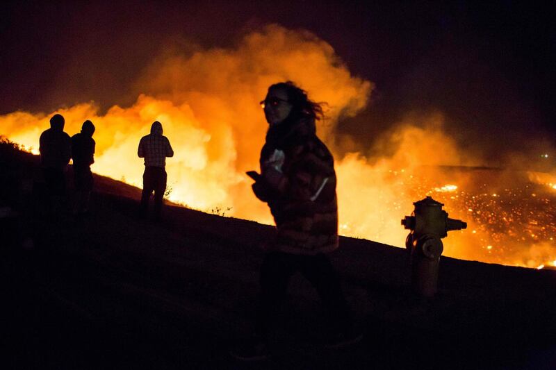 Residents watch homes ablaze in the Shadow Hills neighborhood of Los Angeles during wildfires in California. Kyle Grillot / Reuters