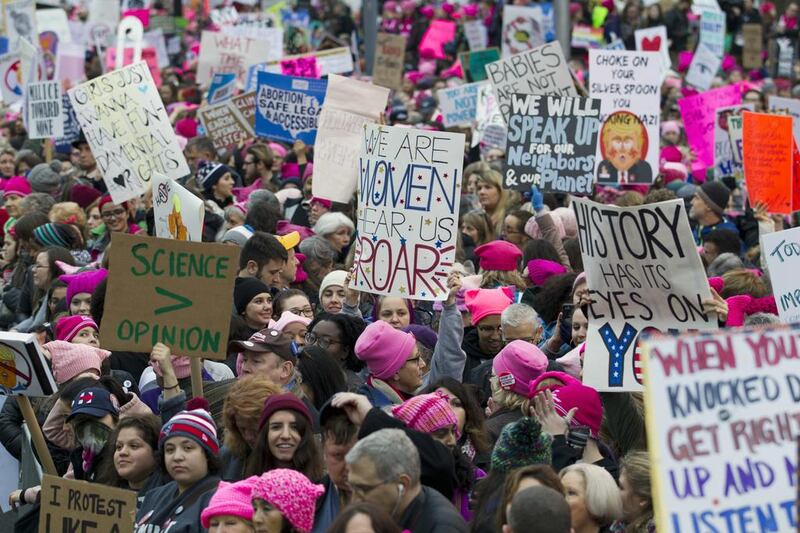 Women with pink hats and signs begin to gather in Washington, DC on January 21, 2017 as part of a day of worldwide protests against the policies of the new US president Donald Trump. Jose Luis Magana / AP Photo