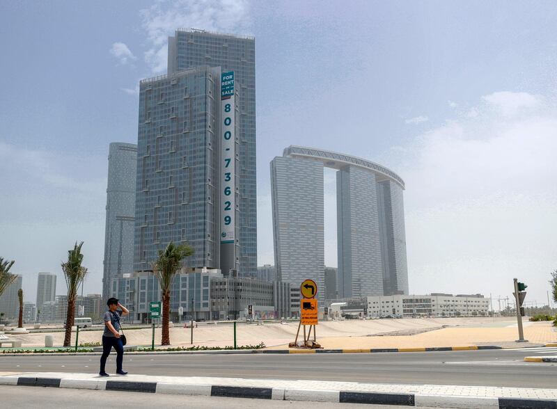 Abu Dhabi, United Arab Emirates, May 19, 2019. –Muggy weather at Al Reem Island.--  A pedestrian crosses the street at Al Reem Island.
Victor Besa/The National
Section:  NA
Reporter: