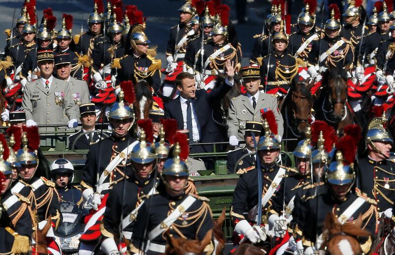 French President Emmanuel Macron and Chief of the Defence Staff French Army General Pierre de Villiers arrive in a command car for the traditional Bastille Day military parade on the Champs-Elysees in Paris, France, July 14, 2017. REUTERS/Gonzalo Fuentes