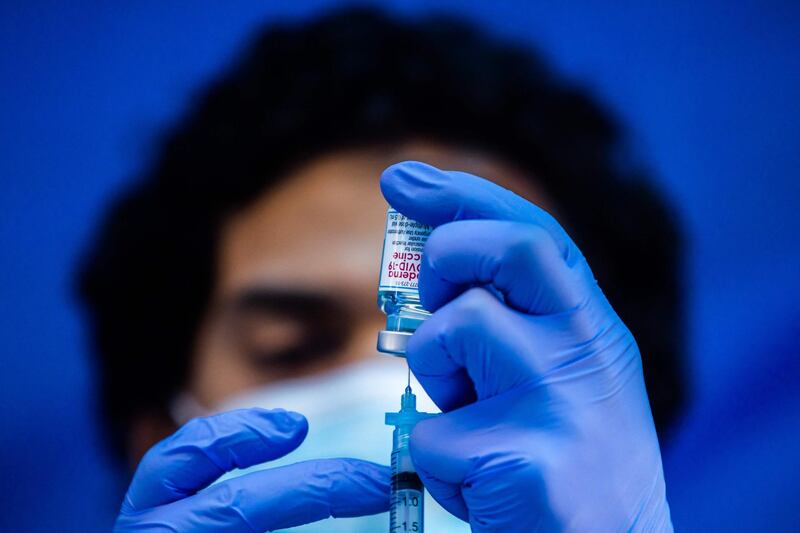 Medical worker Robert Gilbertson loads a syringe with the Moderna Covid-19 vaccine to be administered by nurses at a vaccination site at Kedren Community Health Center, in South Central Los Angeles, California. AFP