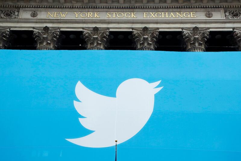 FILE- In this Nov. 7, 2013, file photo, a Twitter sign is draped on the facade of the New York Stock Exchange before its IPO in New York. Twitter reports financial results Thursday, Feb. 7, 2019. (AP Photo/Mark Lennihan, File)