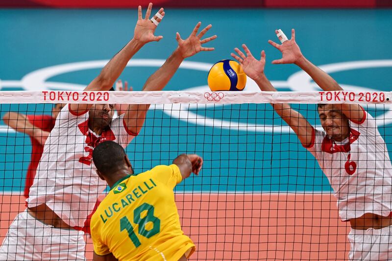 Brazil's Ricardo Souza spikes the ball in the men's preliminary round volleyball match between Brazil and Tunisia. Brazil won 3-0.