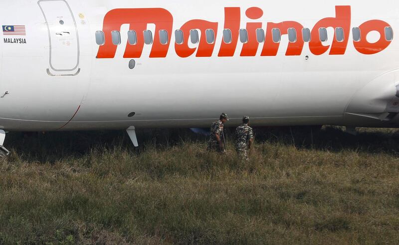 Nepalese security forces examine the Malindo Air plane.  Narendra Shrestha / EPA