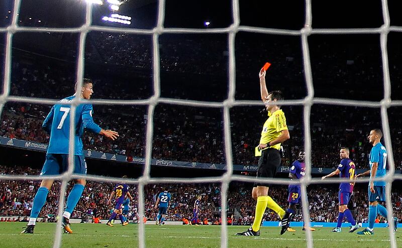Referee Ricardo de Burgos, center right, shows a red card to Real Madrid's Cristiano Ronaldo during the Spanish Supercup, first leg, soccer match between FC Barcelona and Real Madrid at Camp Nou stadium in Barcelona, Spain, Sunday, Aug. 13, 2017. (AP Photo/Manu Fernandez)