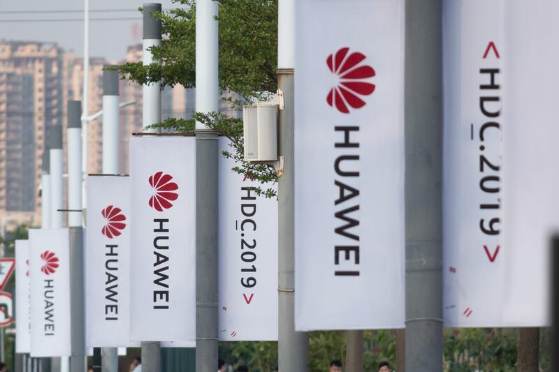 Banners with the Huawei logo are seen outside the venue where the telecom giant unveiled its new HarmonyOS operating system in Dongguan, Guangdong province on August 9, 2019. Chinese telecom giant Huawei unveiled its own operating system on August 9, as it faces the threat of losing access to Android systems amid escalating US-China trade tensions.
 / AFP / FRED DUFOUR
