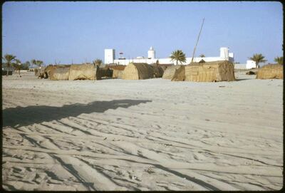Abu Dhabi town 1963. The Ruler's Palace. In the foreground can be seen local houses made of barasti. Photo by David Riley