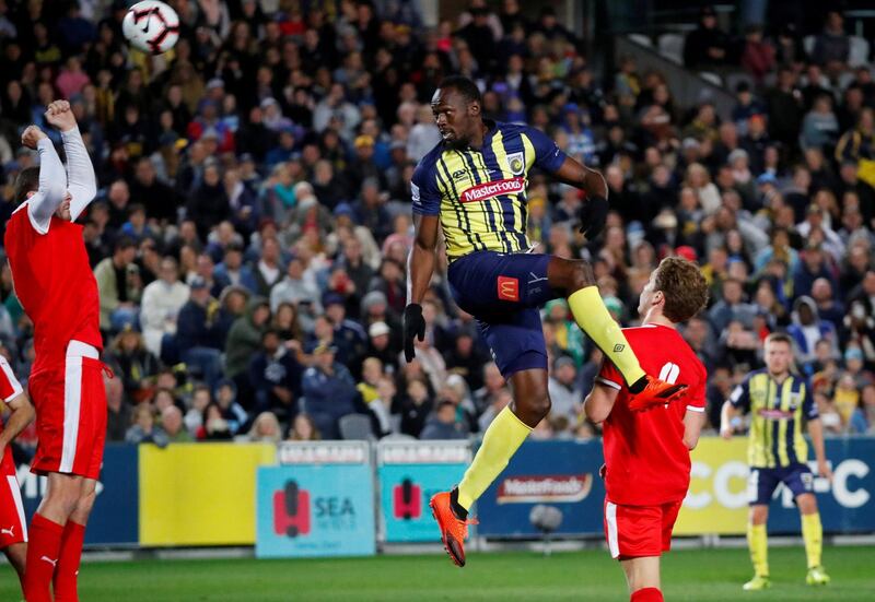 Usain Bolt heads the ball during a pre-season friendly for Central Coast Mariners. AFP