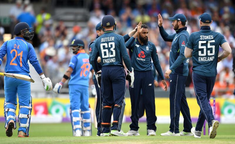 LEEDS, ENGLAND - JULY 17:  Adil Rashid of England celebrates with teammates after dismissing Dinesh Karthik of India during the 3rd Royal London One-Day International match between England and India at Headingley on July 17, 2018 in Leeds, England.  (Photo by Gareth Copley/Getty Images)
