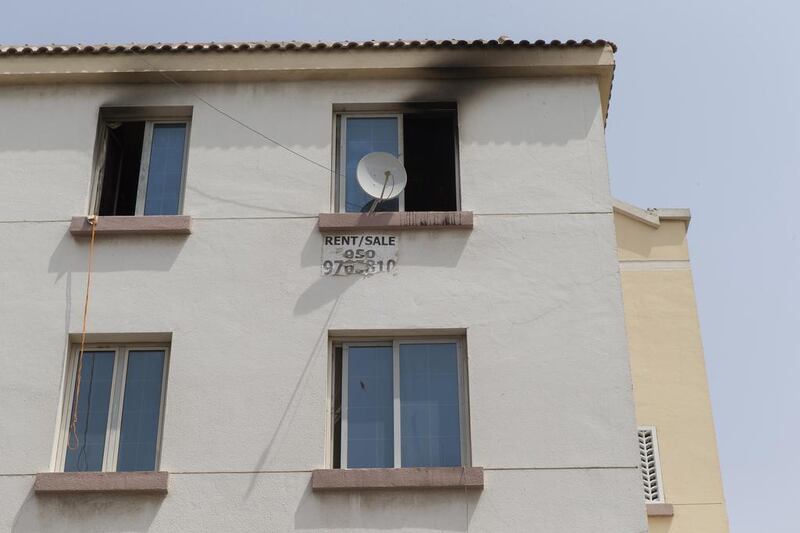 Signs of smoke damage around the windows of a third story apartment in the England Cluster of International City where a fire claimed the lives of two men after they jumped from the balcony. Antonie Robertson / The National